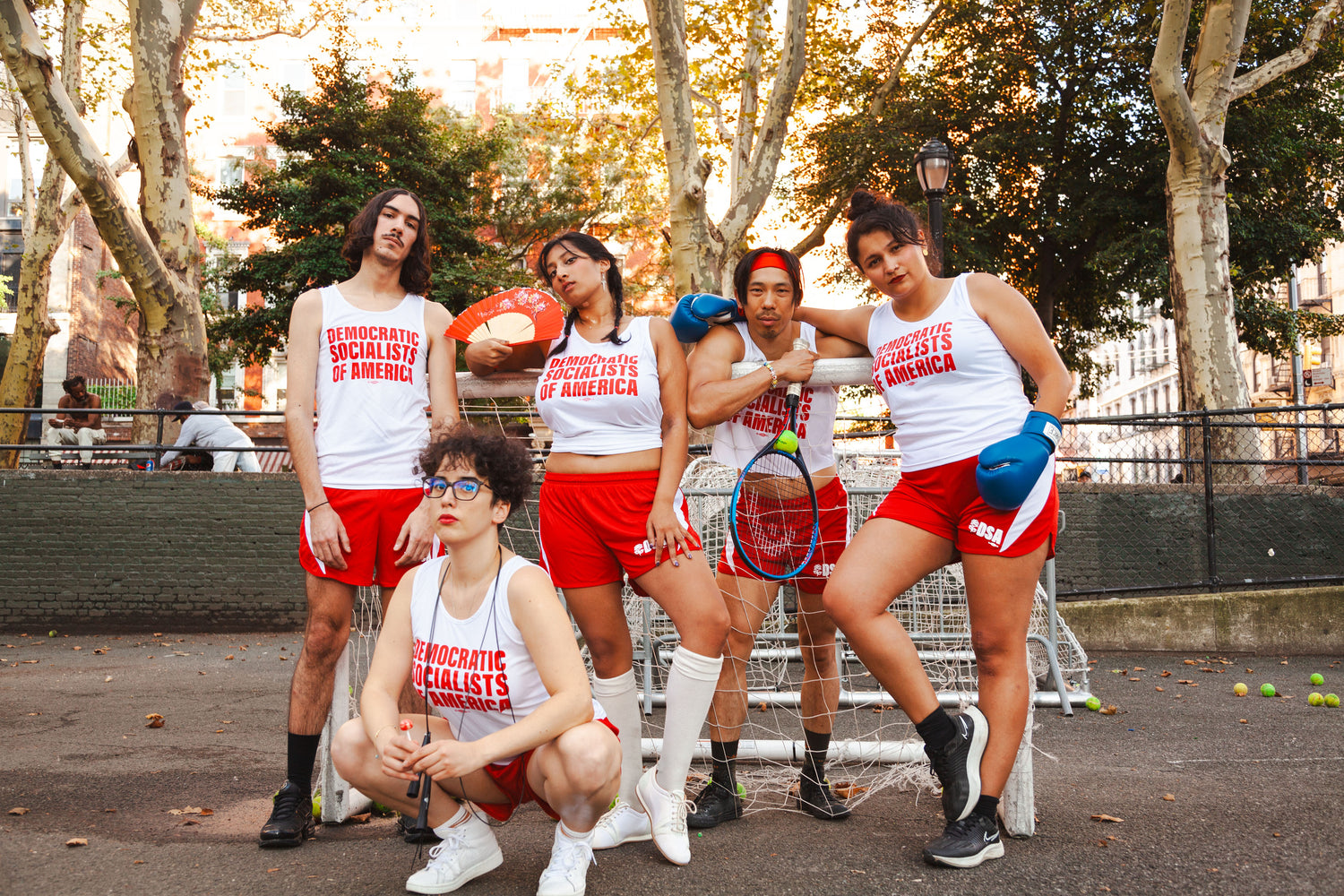 socialists in track uniforms pose in a park