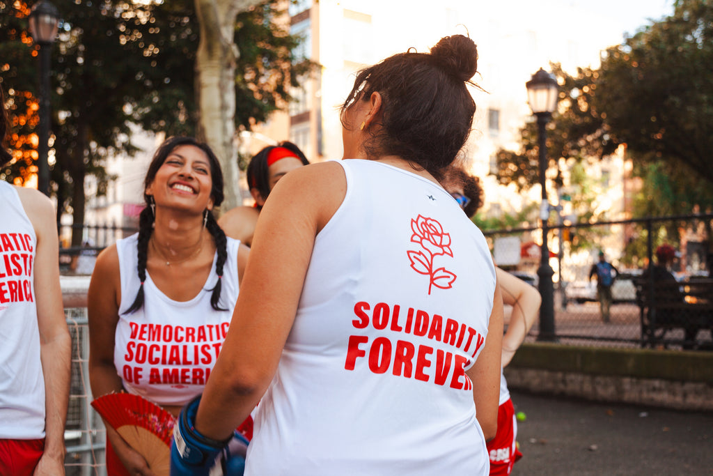 A group of socialists in track uniforms in a public park