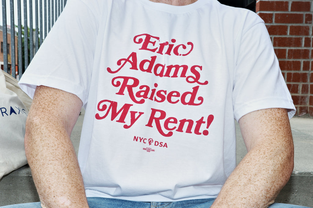 Eric Adams Raised My Rent white t-shirt with red lettering. NYC-DSA logo at the bottom