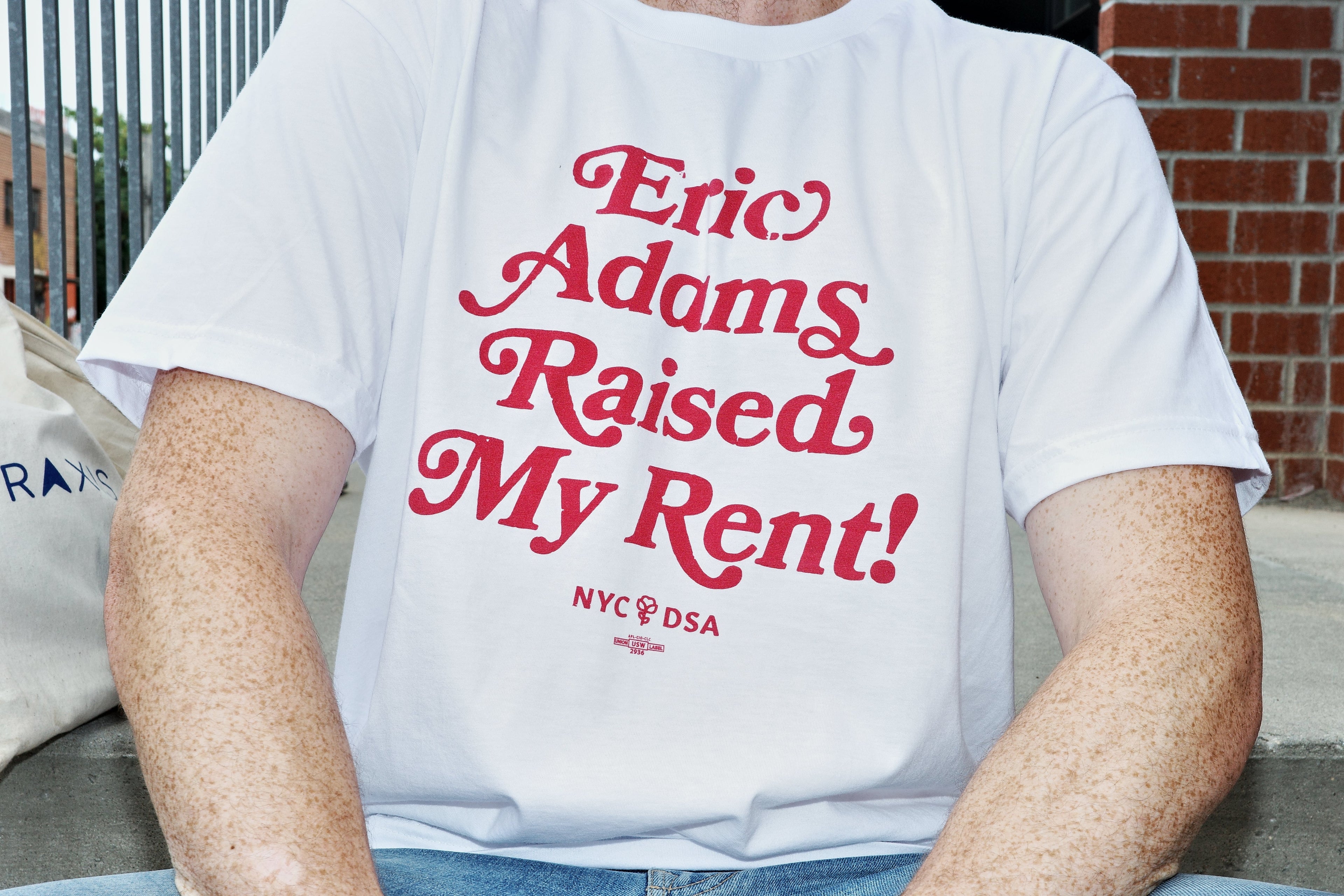 Eric Adams Raised My Rent white t-shirt with red lettering. NYC-DSA logo at the bottom
